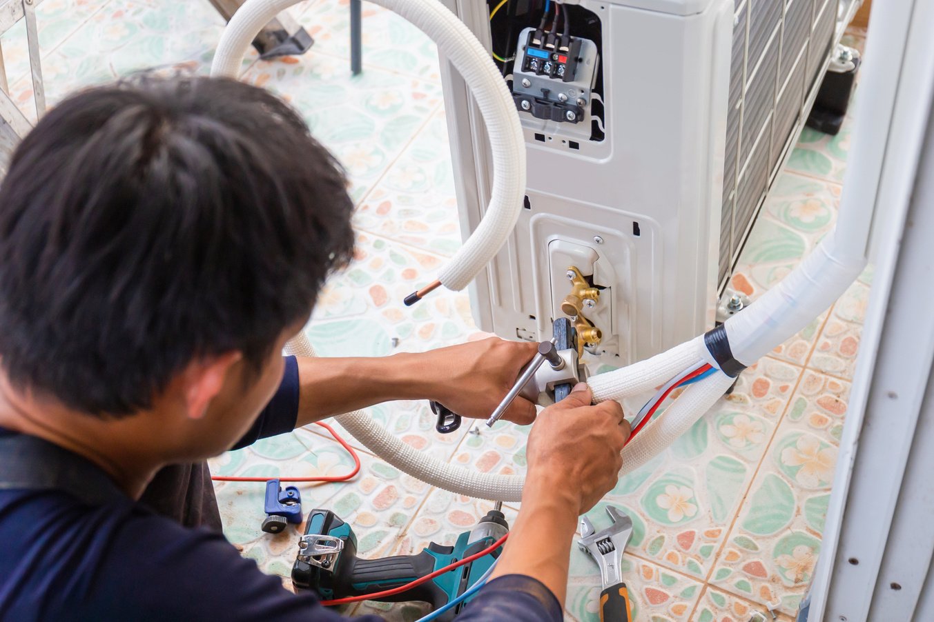 Air conditioning technicians install new air conditioners in homes, Repairman fix air conditioning systems, Male technician service for repair and maintenance of air conditioners