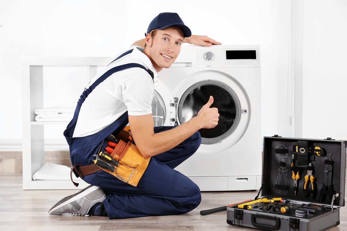 Plumber Repairing Washing Machine