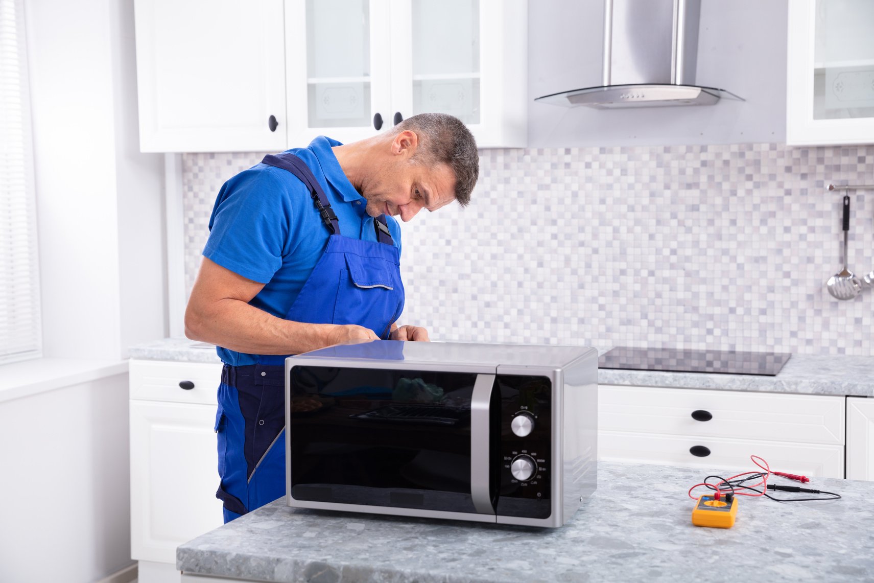 Man Repairing Microwave Oven